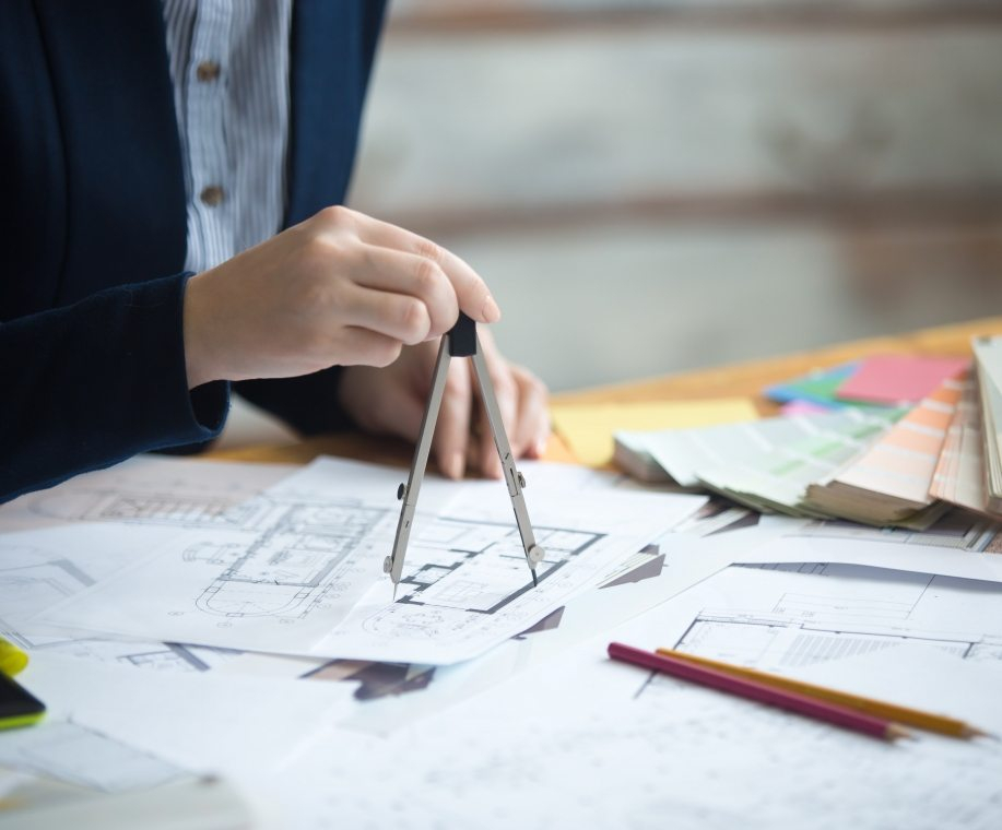 female-architect-using-drawing-compass